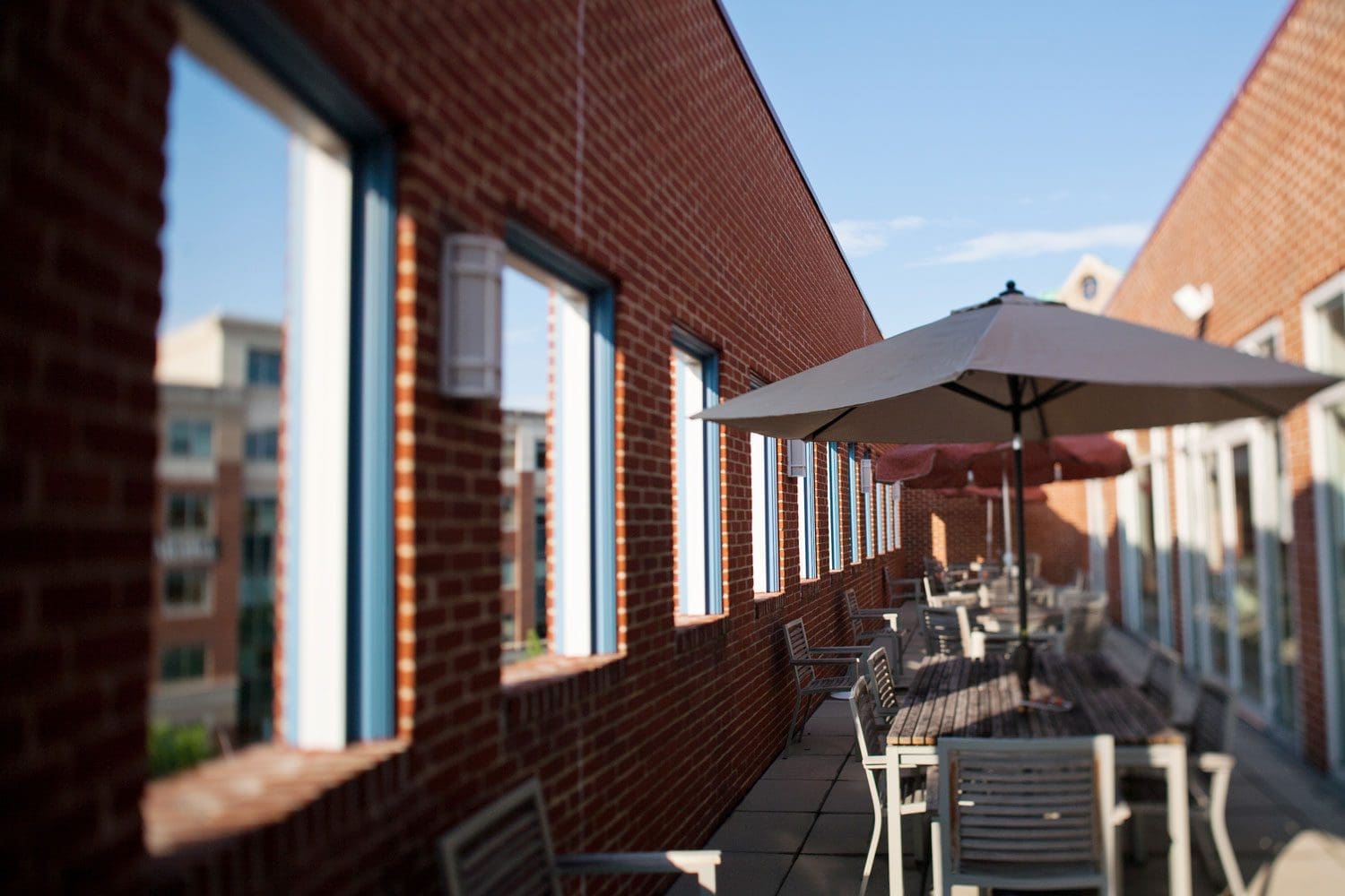 Outdoor patio featuring plenty of seating including tables with awnings